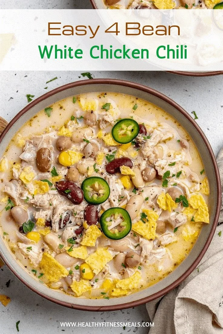 Delicious bowl of best white chicken chili garnished with cilantro and cheese.