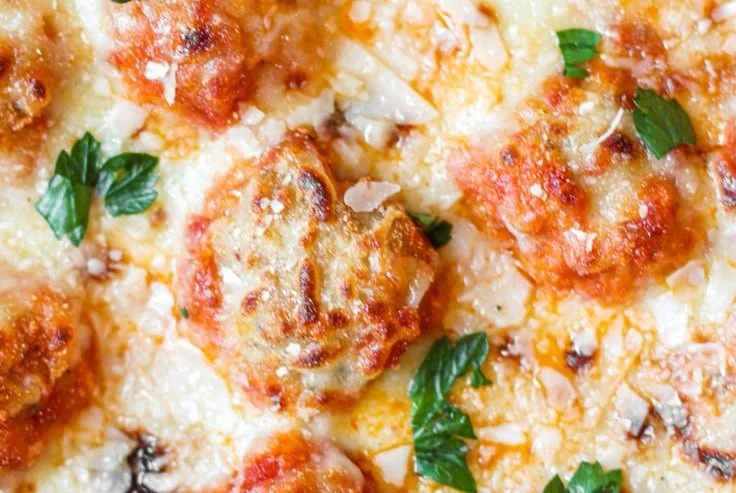 Delicious Chick Parm Meatballs served with marinara sauce and melted cheese