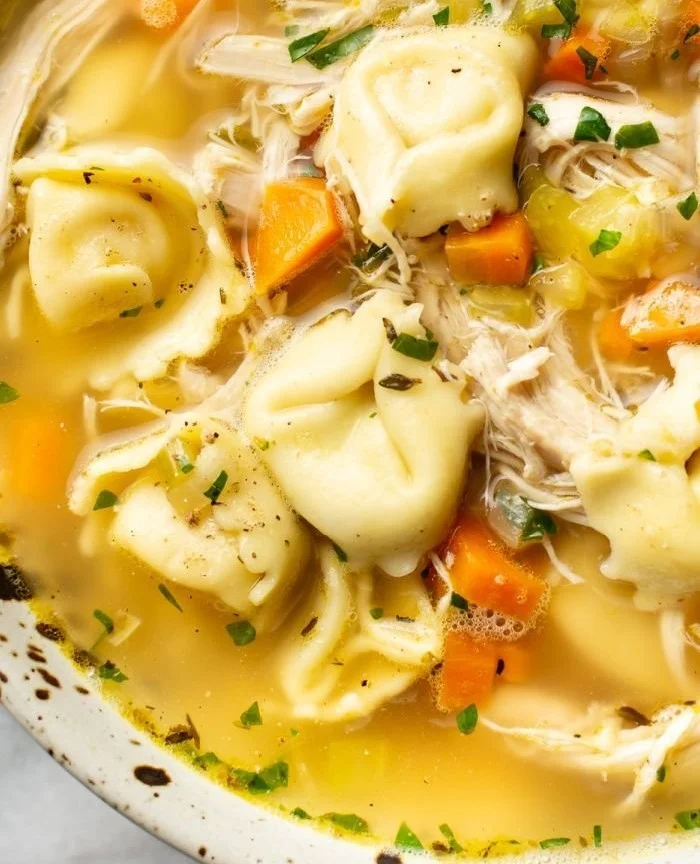 Delicious Chicken Tortellini Soup in a bowl with fresh herbs