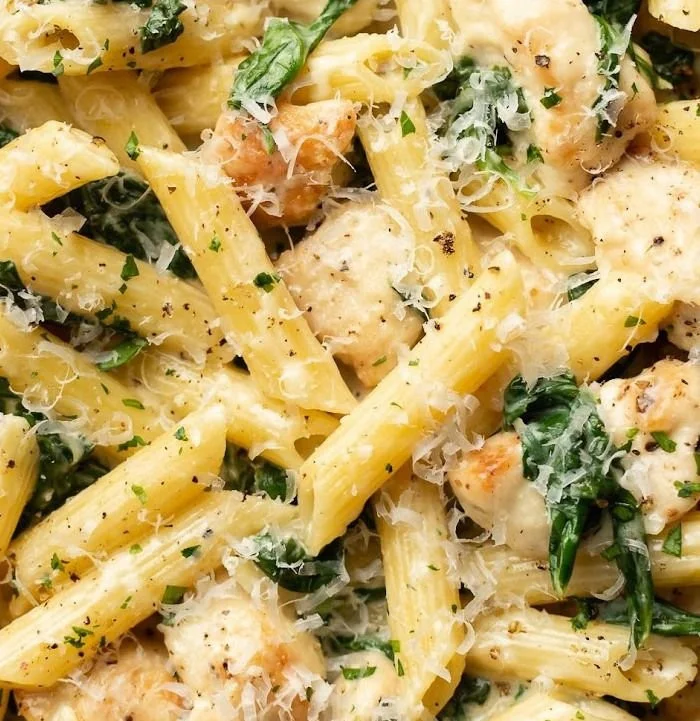 Easy spinach chicken pasta dish served in a bowl with fresh ingredients