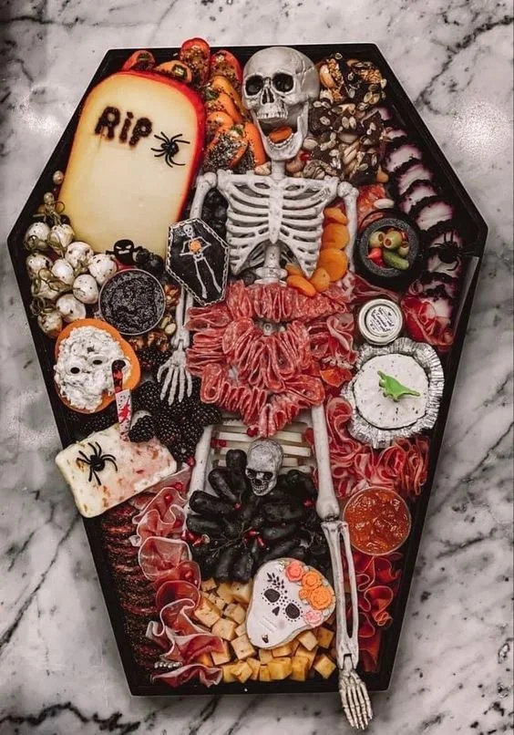 Spooky Halloween food including appetizers and a colorful charcuterie board.