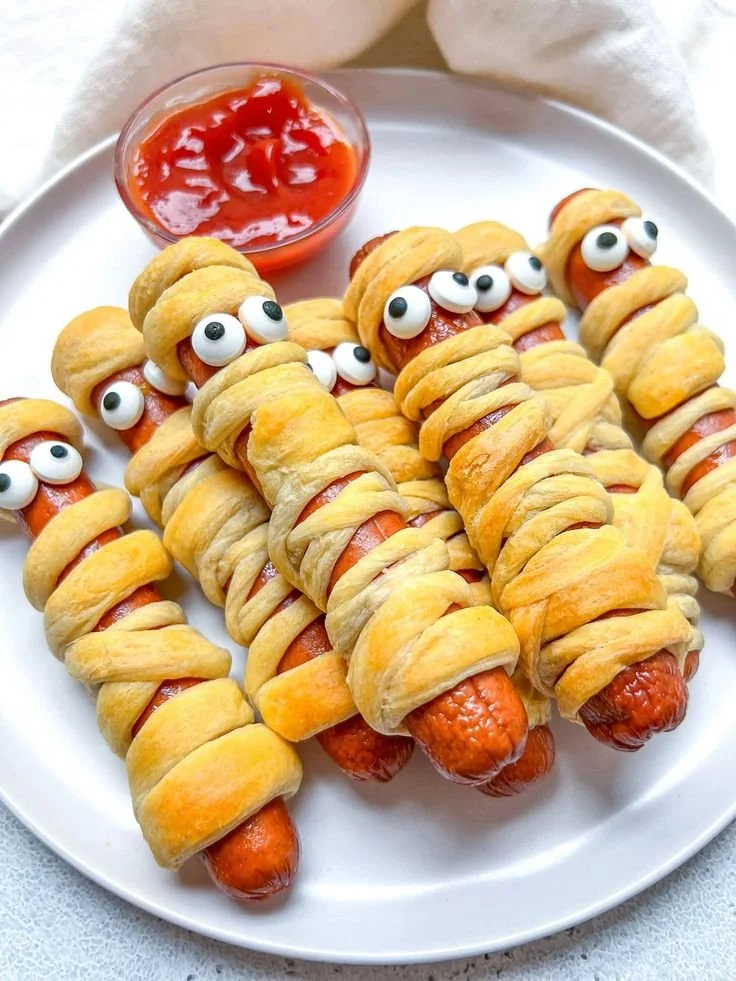 Halloween mummy hotdogs wrapped in crescent dough for spooky fun