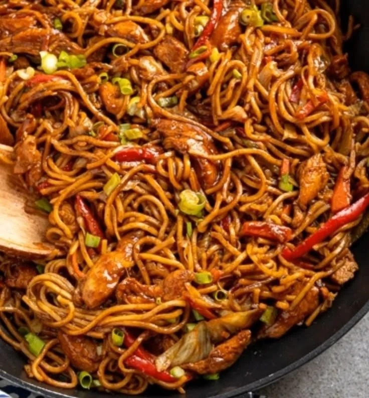 Delicious Hoisin Chicken with Noodles garnished with vegetables