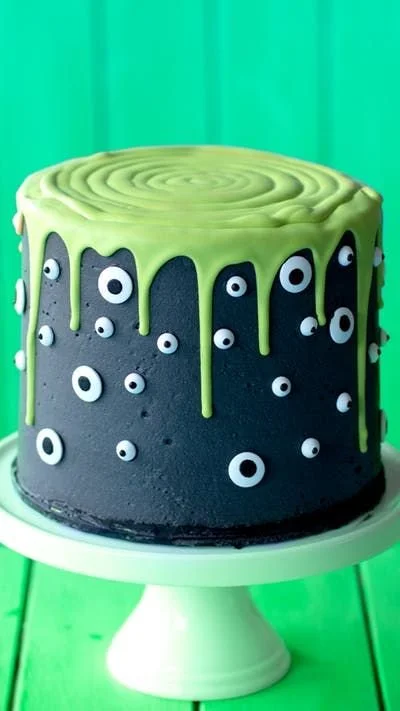 Delicious Monster Slime Cake decorated with gooey green slime and monster themes.