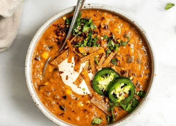 Bowl of One Pot Vegan Tortilla Soup topped with avocado and tortilla strips