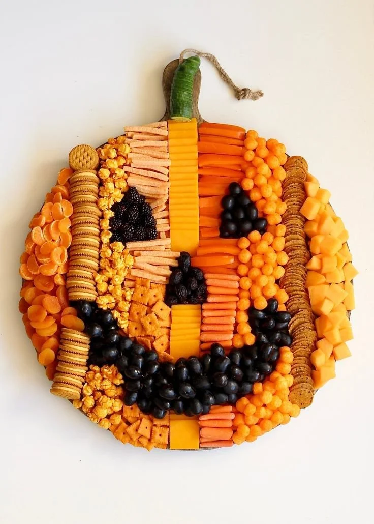 Colorful Pumpkin Snack Board with seasonal treats and decorations
