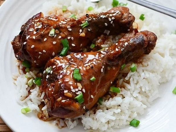 Slow Cooker Honey Garlic Chicken Legs garnished and ready to serve.