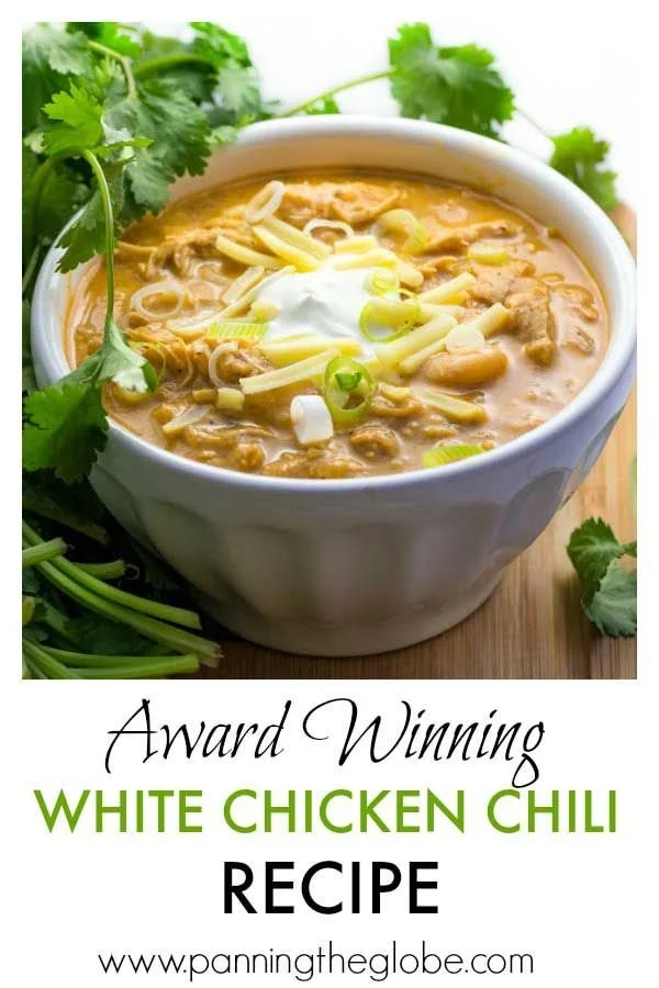 Bowl of award-winning white chicken chili topped with cilantro and jalapenos