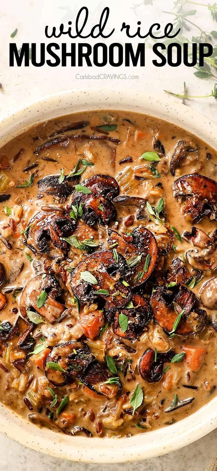 Creamy wild rice mushroom soup in a bowl garnished with fresh herbs