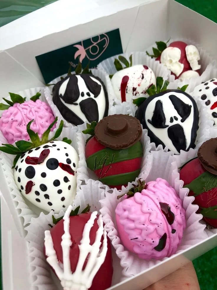 Delicious Halloween treats: chocolate covered strawberries in spooky designs