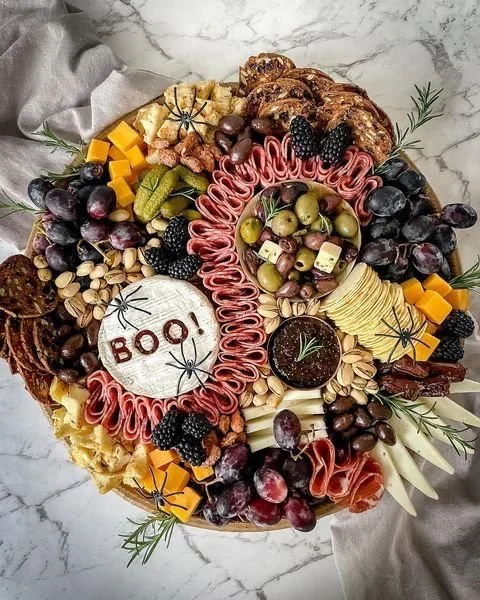 Halloween charcuterie board featuring spooky snacks and fall treats.