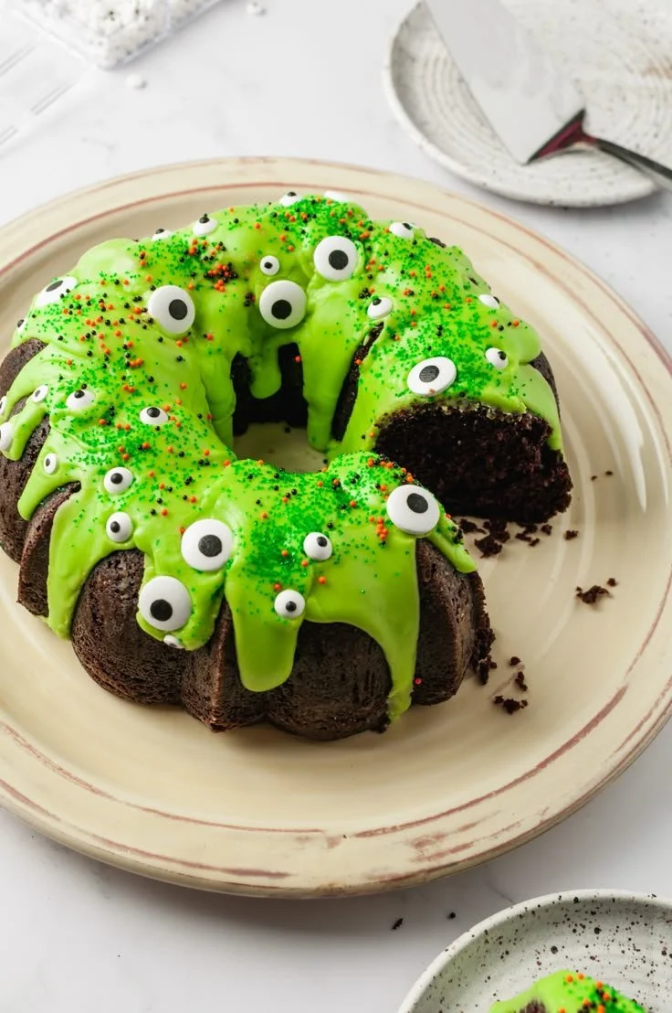 Spooky Halloween cake decorated with ghosts, pumpkins, and cobwebs.