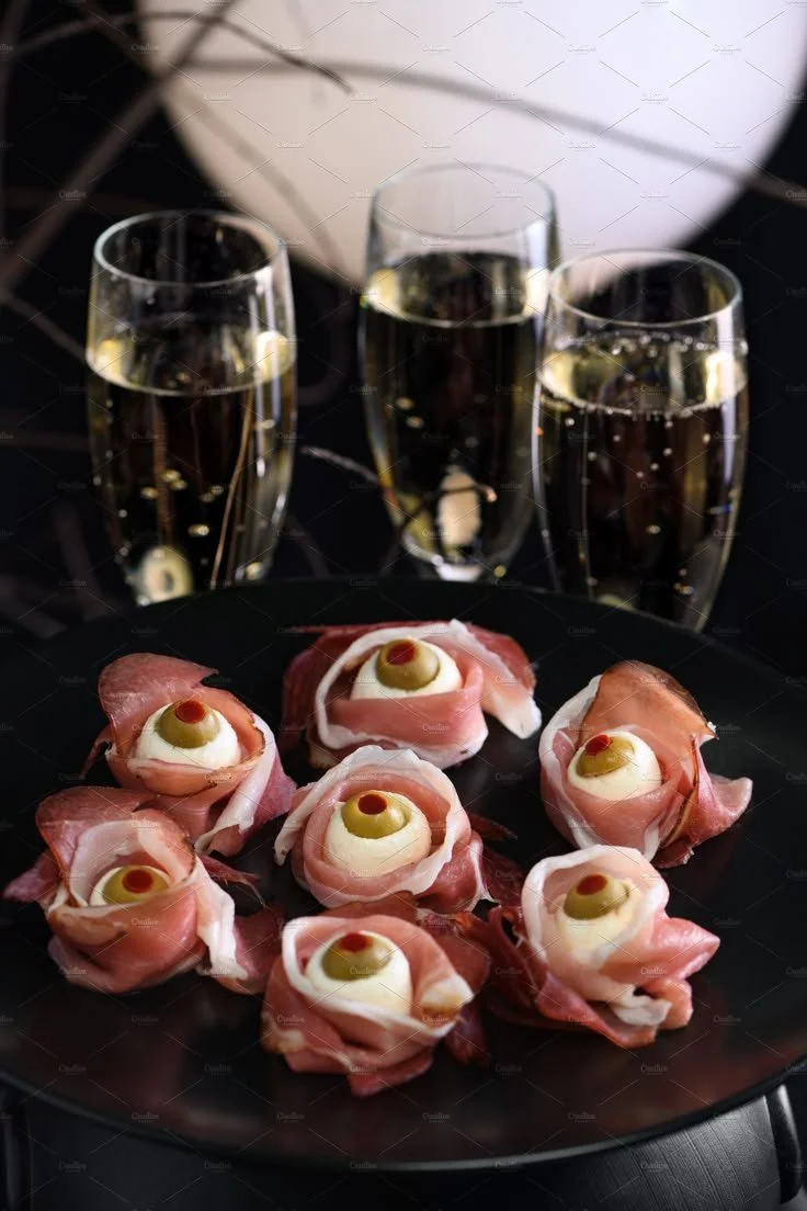 Halloween snack eyeballs made of jerked beef and cured meats on a festive platter.