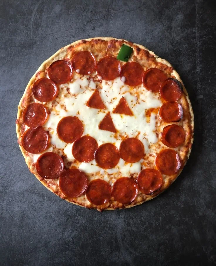 Spooky Jack-O'-Lantern Pizza decorated for Halloween