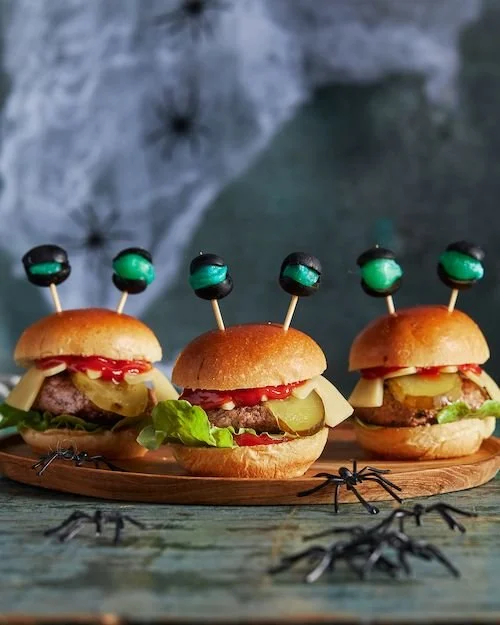 Delicious spooky monster burgers served at a Halloween party with space theme decorations.