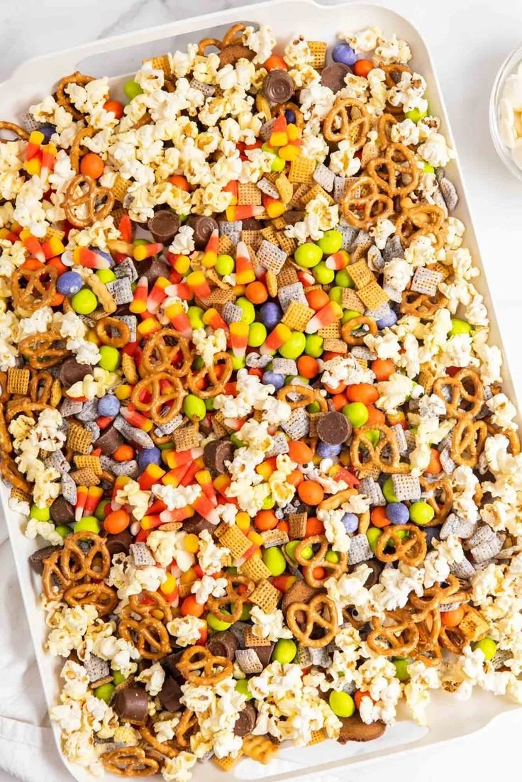 Colorful Halloween snack mix with candy corn, Bugles, and Chex for a festive treat.